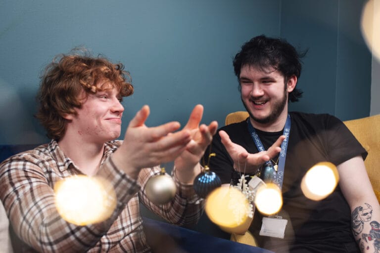 Blue Triangle staff and supported people holding Christmas decorations