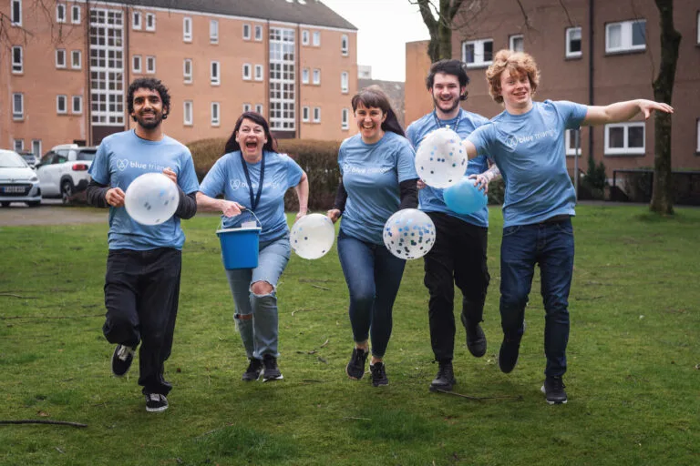Fundraisers wearing Blue Triangle t-shirts
