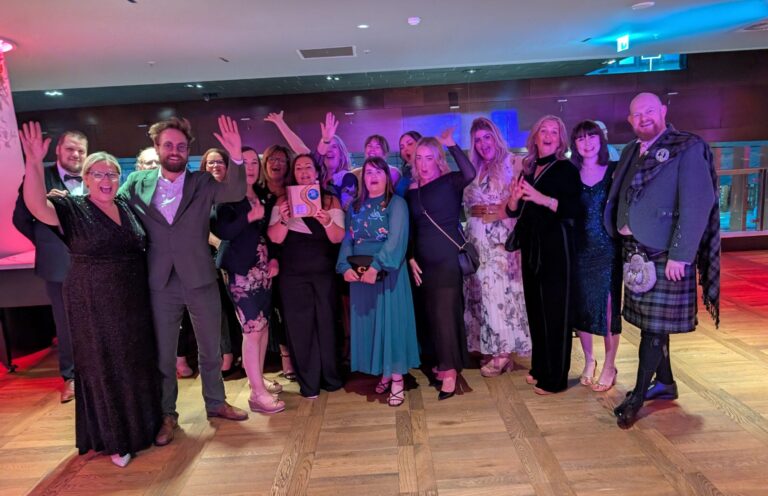 Group image of Blue Triangle staff who attended SCVO awards with their award.